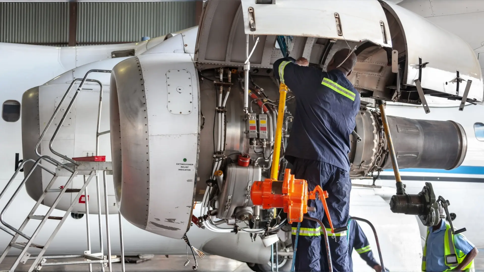 Technicians performing aircraft engine maintenance using a laser marking system, showcasing the precision and durability of laser marking technology for aerospace applications, available for purchase on our laser products site.